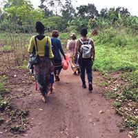 Study team members walk to a household with the Village Health Team representative. Photo by Rashid Muyingo