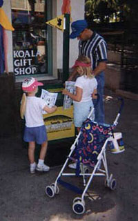 Father and his children looking at the tipsheet